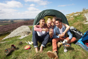 group-young-people-checking-mobile-phone-camping-trip-relaxing-33913834-300x200 Outdoor Activities To Relieve Stress